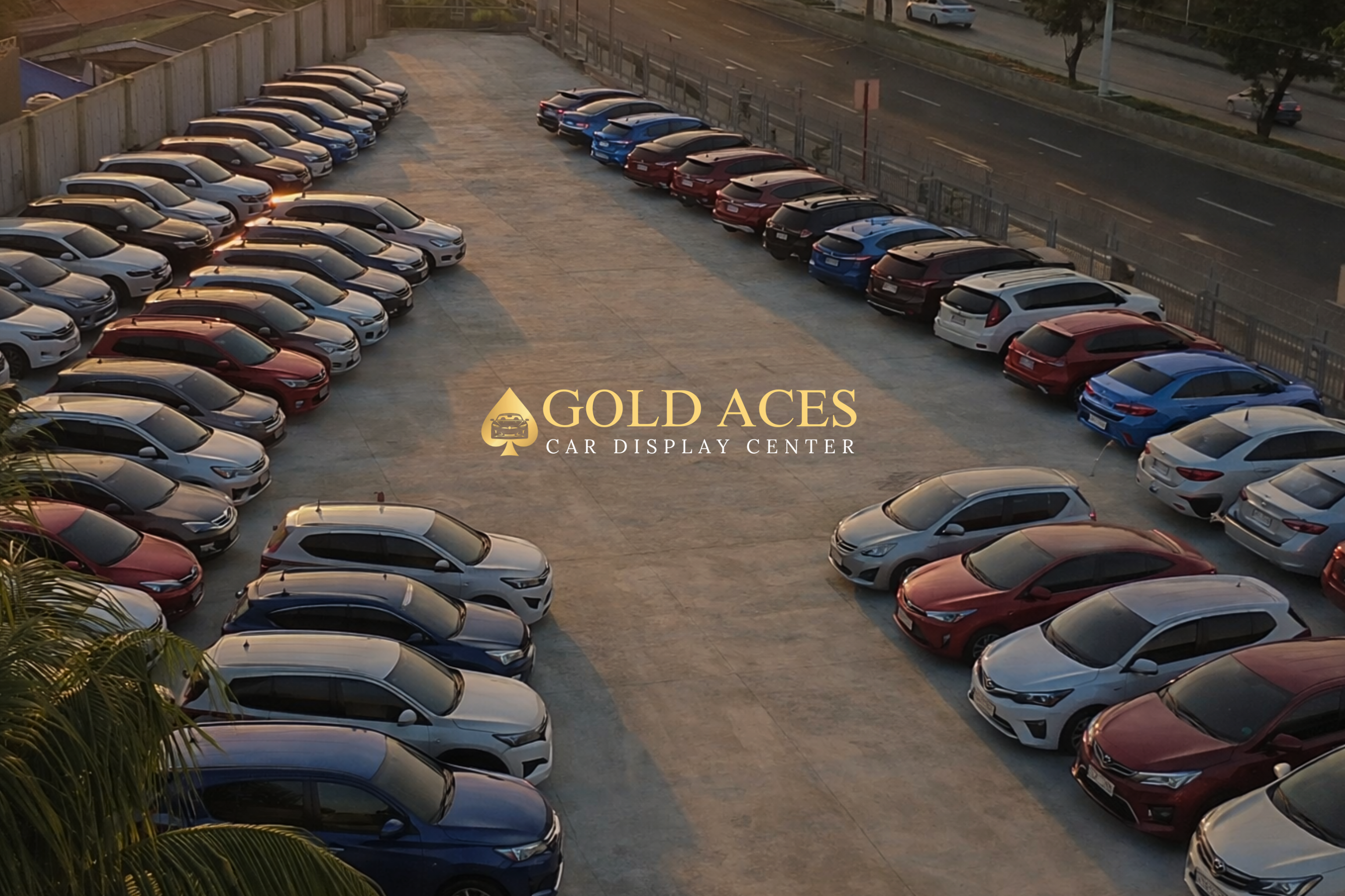 Multiple quality secondhand cars parked in a lot with 'Gold Aces Car Display Center' branding.